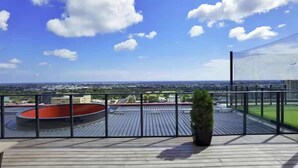 A rooftop terrace with a clear view of the cityscape, a circular pool, and a potted plant. - Prime 2BR City Escape Walkable CBD Free Parking (Adelaide)