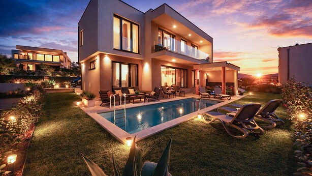 A modern two-story house with a swimming pool, outdoor seating, and a sunset view. - House 2417/192118 (Istria - Medulin), 250m from the beach (Medulin)