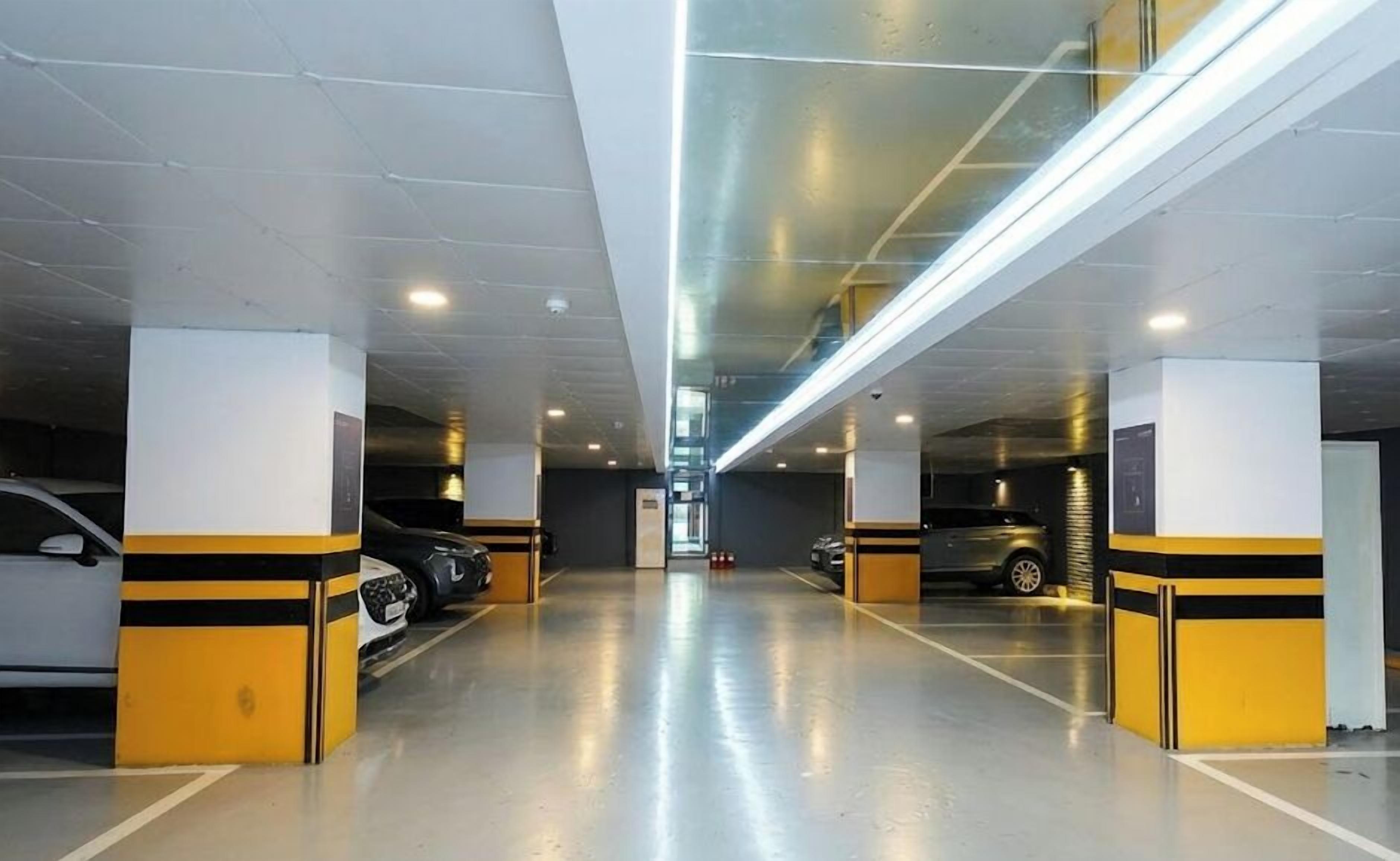 A multi-level parking garage with cars parked on both levels.