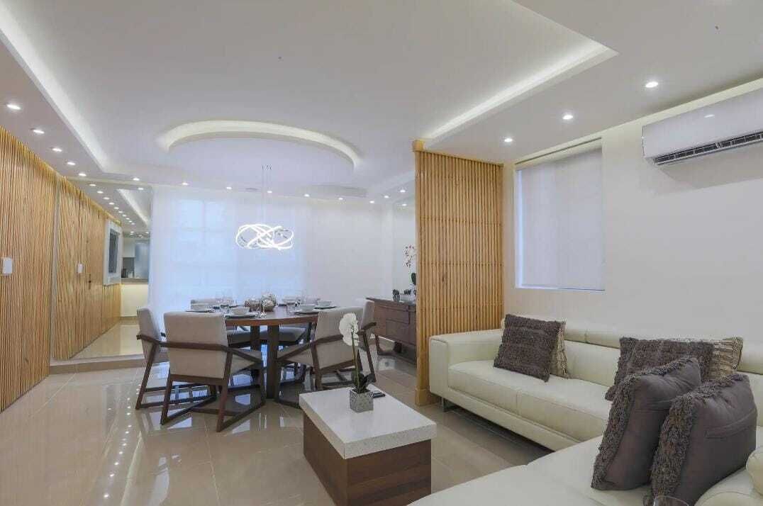 A modern living room with a dining area, a sofa, and a coffee table.