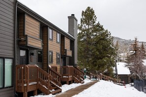 A modern building with wooden paneling and a chimney. - Canyons Retreat: Alpine Charm, Shared Hot Tub/Pool, Sleeps 10, Cozy Fireplace (Park City)