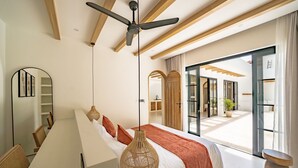 A modern bedroom with a large bed, a ceiling fan, a hanging rattan light, and a view of the outdoor area. - Palmera Aalto Bingin (Pecatu)