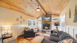 A cozy living room with a fireplace, wooden ceiling, and a sofa set. - 3 BR Beech Mtn Basecamp: 2 Mi to Resort, Fireplace & Firepit (Beech Mountain)