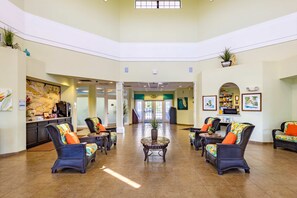A spacious lobby with comfortable seating, a reception desk, and a large map on the wall. - 3rd floor condo w/ gym, balcony, shared pools, hot tub, sauna, near theme parks (Kissimmee)