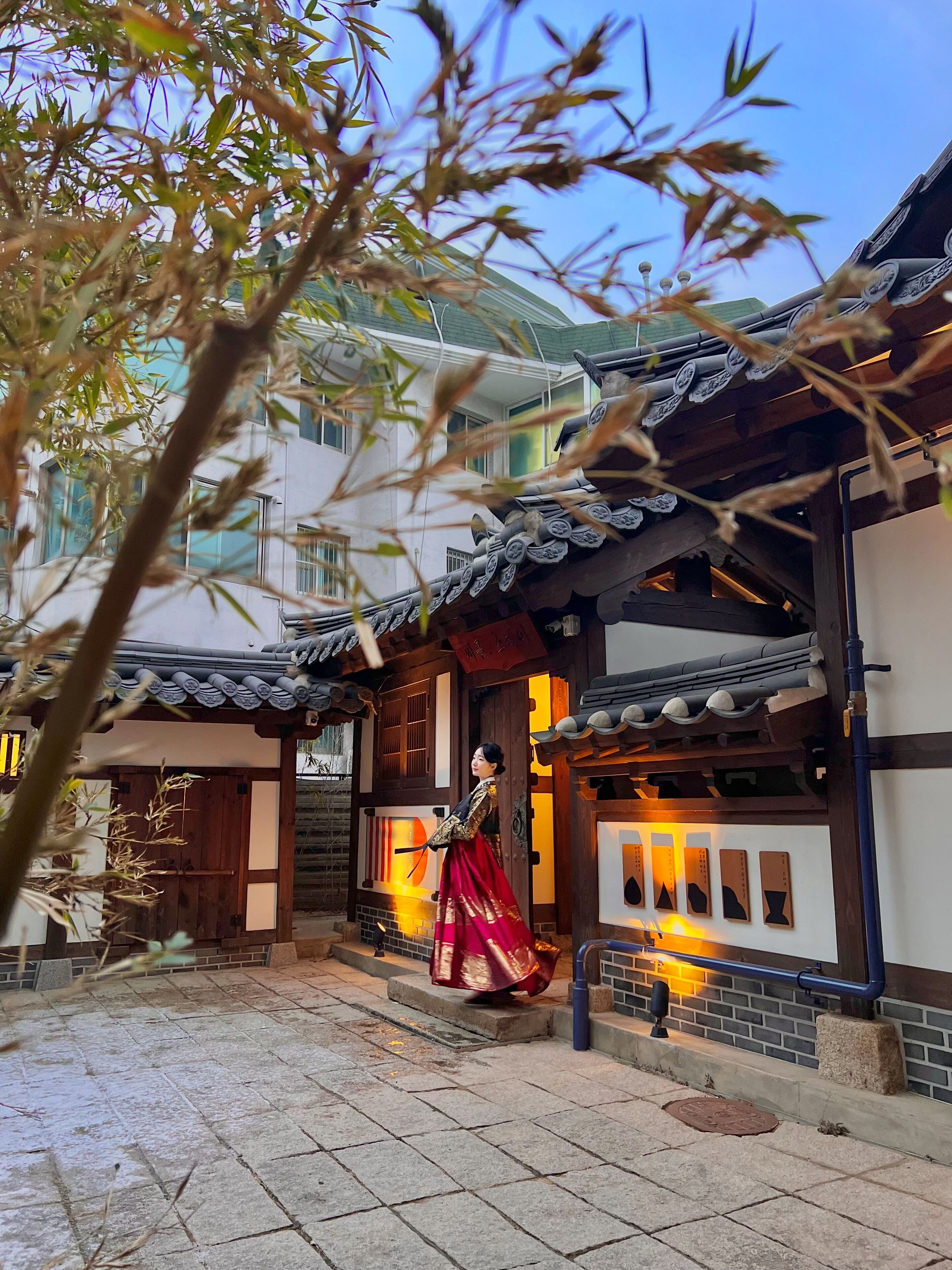 A traditional building with a tiled roof and wooden doors.