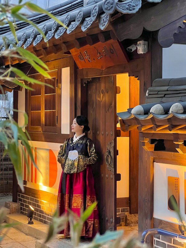 Un edificio coreano tradicional con una puerta de madera y un letrero encima.