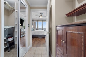 A bedroom with a bed, a ceiling fan, a dresser, and a view of the outdoors. - Amazing Gulf Views! Legacy Towers 10th Floor! (Gulfport)