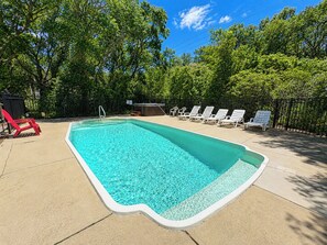 A rectangular swimming pool with a white edge, surrounded by a concrete deck. - Our Haven - 5 BR Soundside Vacation Home in Duck w/Private Pool, Dogs Allowed (Duck)