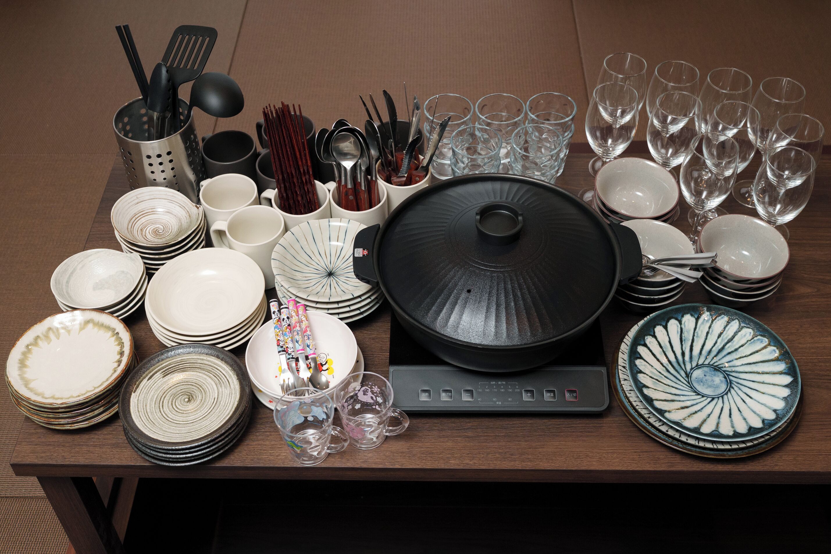 A table with various dishes, glasses, and utensils.