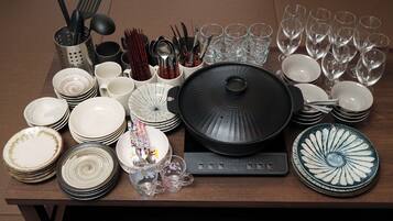 A table with various dishes, glasses, and utensils.