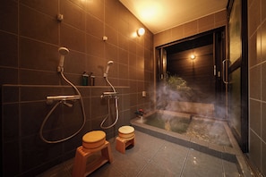 A modern bathroom with a bathtub, two toilets, and a shower. - Yuyado Tomoshibi (Beppu)
