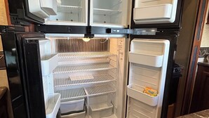 A kitchen with a built-in refrigerator, a sink, and a countertop. - The Premier Cuero Tx RV ,No Cleaning Fee,King Bed, Sectional Couch (Cuero)