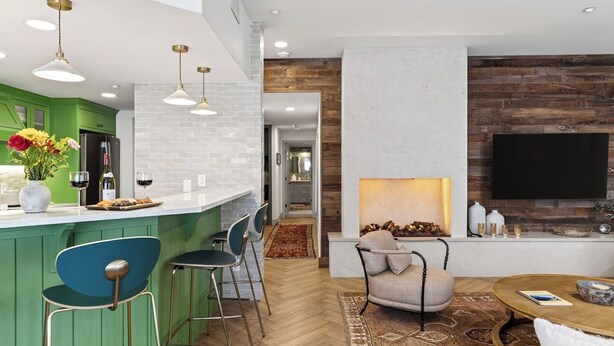 A modern kitchen with green cabinets, a bar area, and a seating space with a fireplace. - Misty Maiden Lodge by Avantstay Prime Ski-in Ski-out Retreat + Hot Tub + Steps to Lift & Gondola (Telluride)
