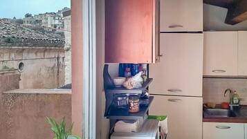 A small kitchen with a window overlooking a cityscape.