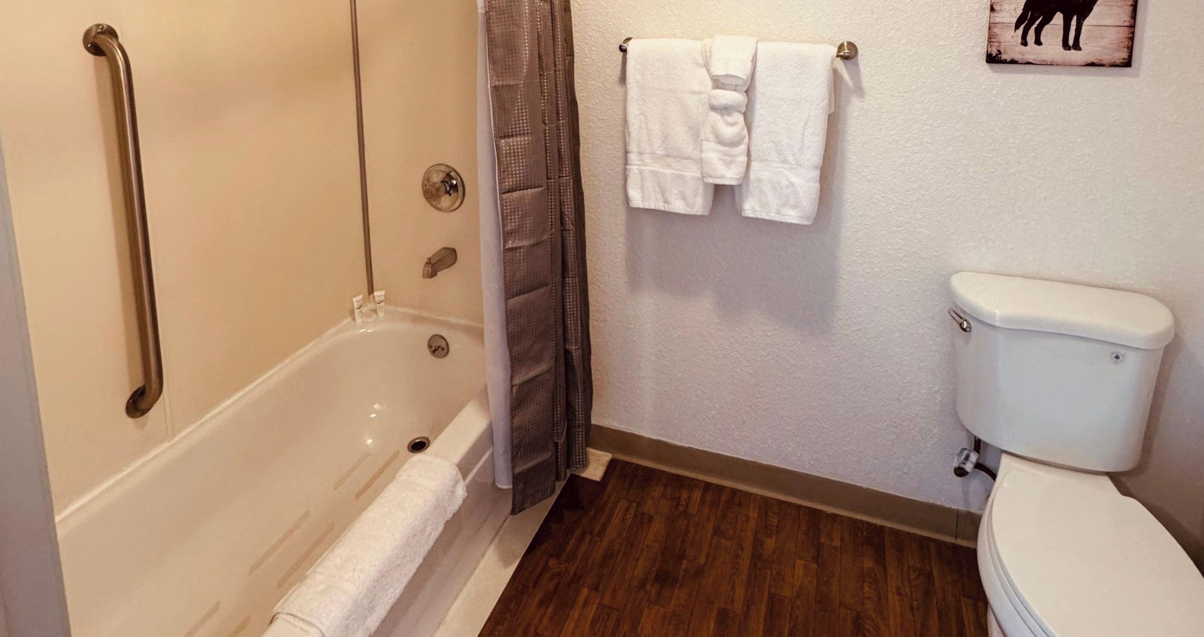 A bathroom with a bathtub, a toilet, and a shower.