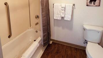 A bathroom with a bathtub, a toilet, and a shower.
