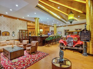 A classic interior with a vintage car display, leather seating, and a bar area.