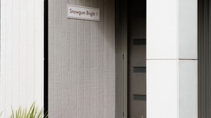 A building entrance with a sign reading 'Snowgum Bright 1'. - Snowgum Bright 1 - 3 Bedroom, 3 Bathroom (Bright)
