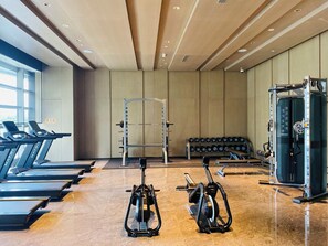 A gym with treadmills, a weight bench, and a squat rack. - Dhawa Xi'an Chanba (Xi'an)