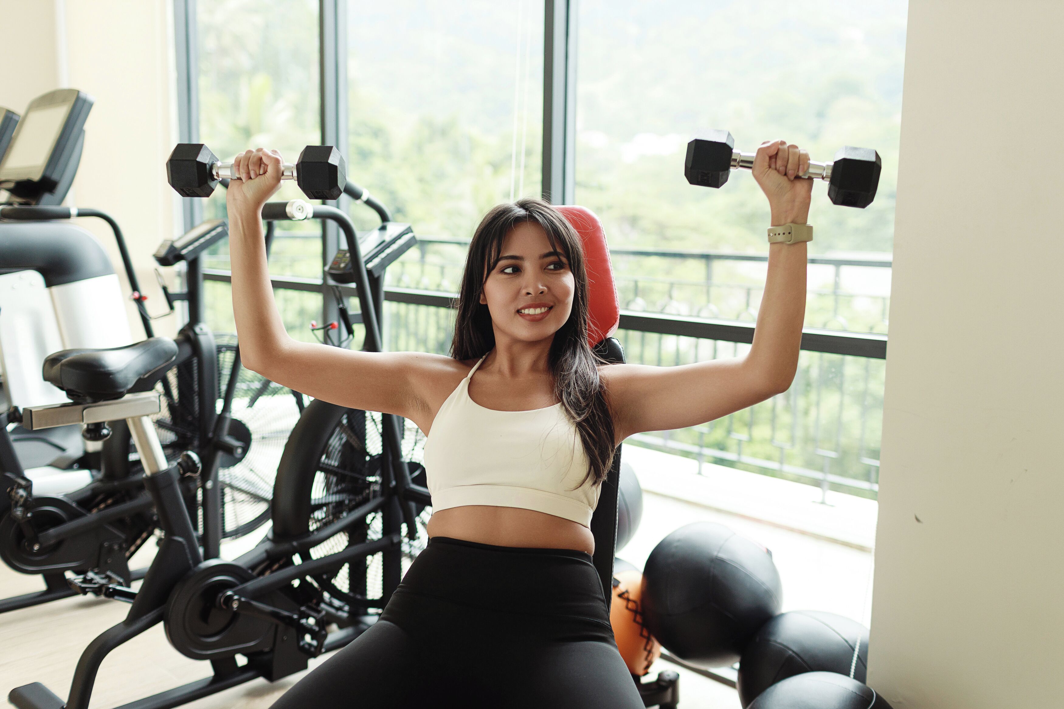 A gym with exercise equipment, including a stationary bike and dumbbells.
