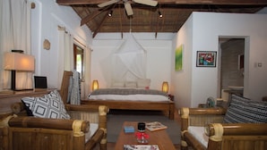 A bedroom with a bed, wooden furniture, a ceiling fan, and a bedside table with a lamp. - Palay (Malay)