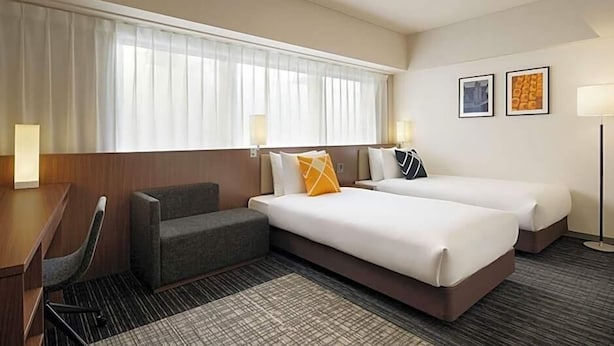A hotel room with two beds, a desk, and a couch. - Hotel Unizo Kyoto Karasuma Oike (Kyoto)