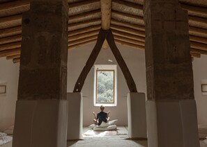 A room with a high ceiling, wooden beams, and a large window. - Es Racó D Artá (Arta)