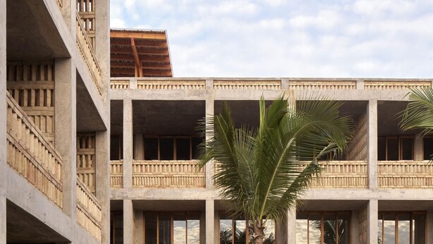 A multi-story hotel with balconies, a swimming pool, and outdoor seating. - Hotel Humano (Santa María Colotepec)