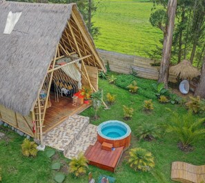A thatched-roof hut with a small pool and outdoor seating area. - Samay Collections (Tababela)