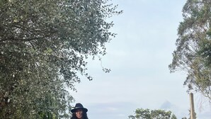 Two people riding horses on a cobblestone path with trees and a sign that reads "Samay Collections" in the background. - Samay Collections (Tababela)