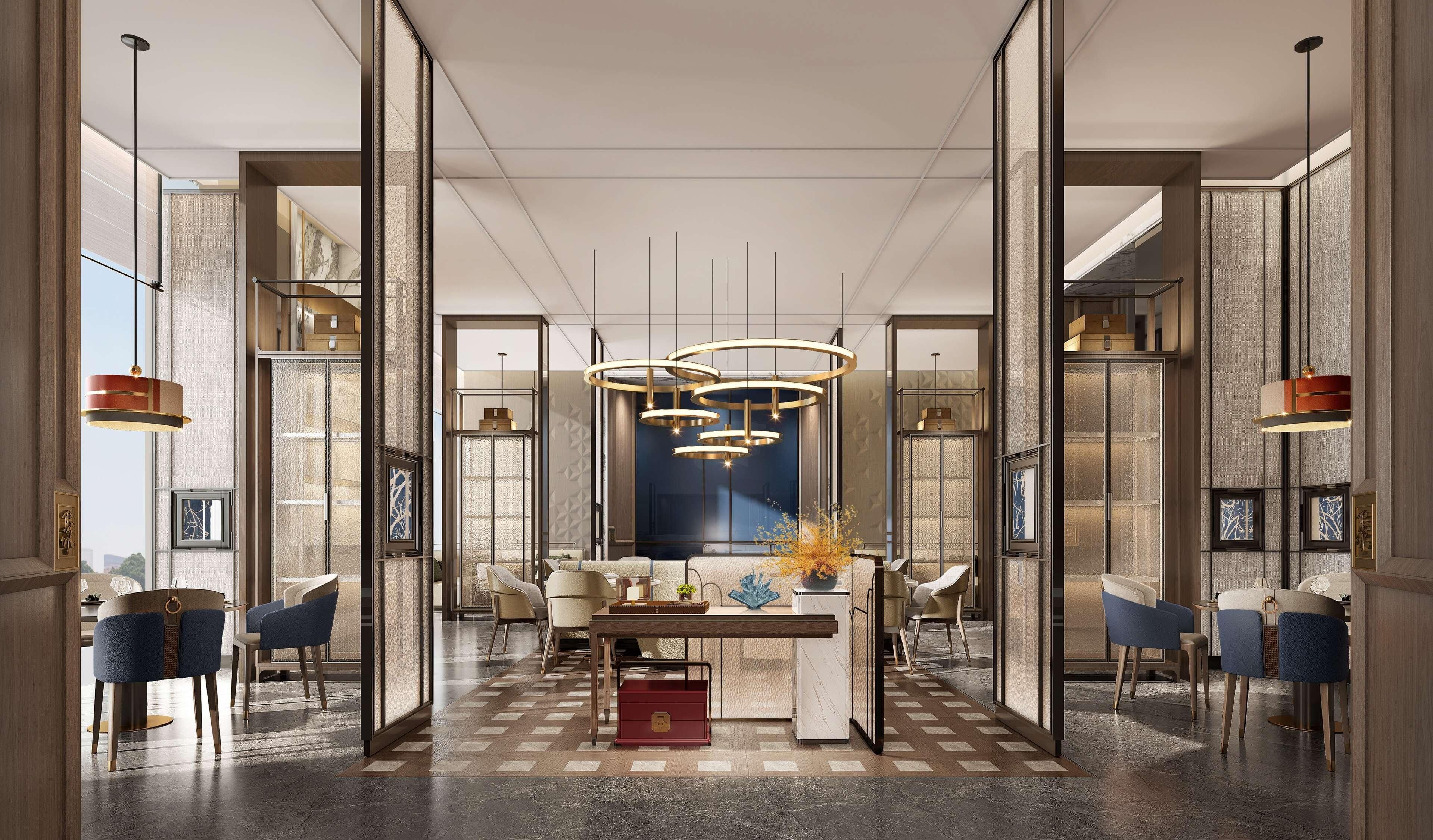 Un intérieur moderne avec un espace de repas central, de nombreux coins salon et des luminaires contemporains.