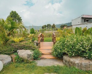 Un sendero de madera que conduce a un edificio con vistas a un paisaje montañoso.
