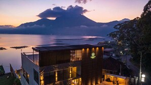 A modern building with a flat roof, large windows, and a well-lit entrance. - Tribhuwana Padma Resort (Kintamani)