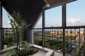 Un balcone con vista sulla città, tra edifici e strade.