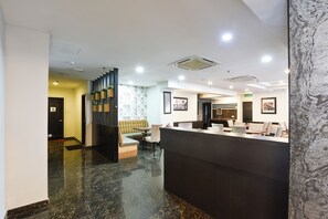 A modern reception area with a marble floor, a reception desk, seating area, and a staircase leading to another level. - Palette Kl Sentral Near Pudu Lrt (Kuala Lumpur)