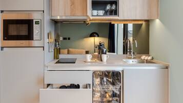 A compact kitchen with a microwave, a dishwasher, and a sink.