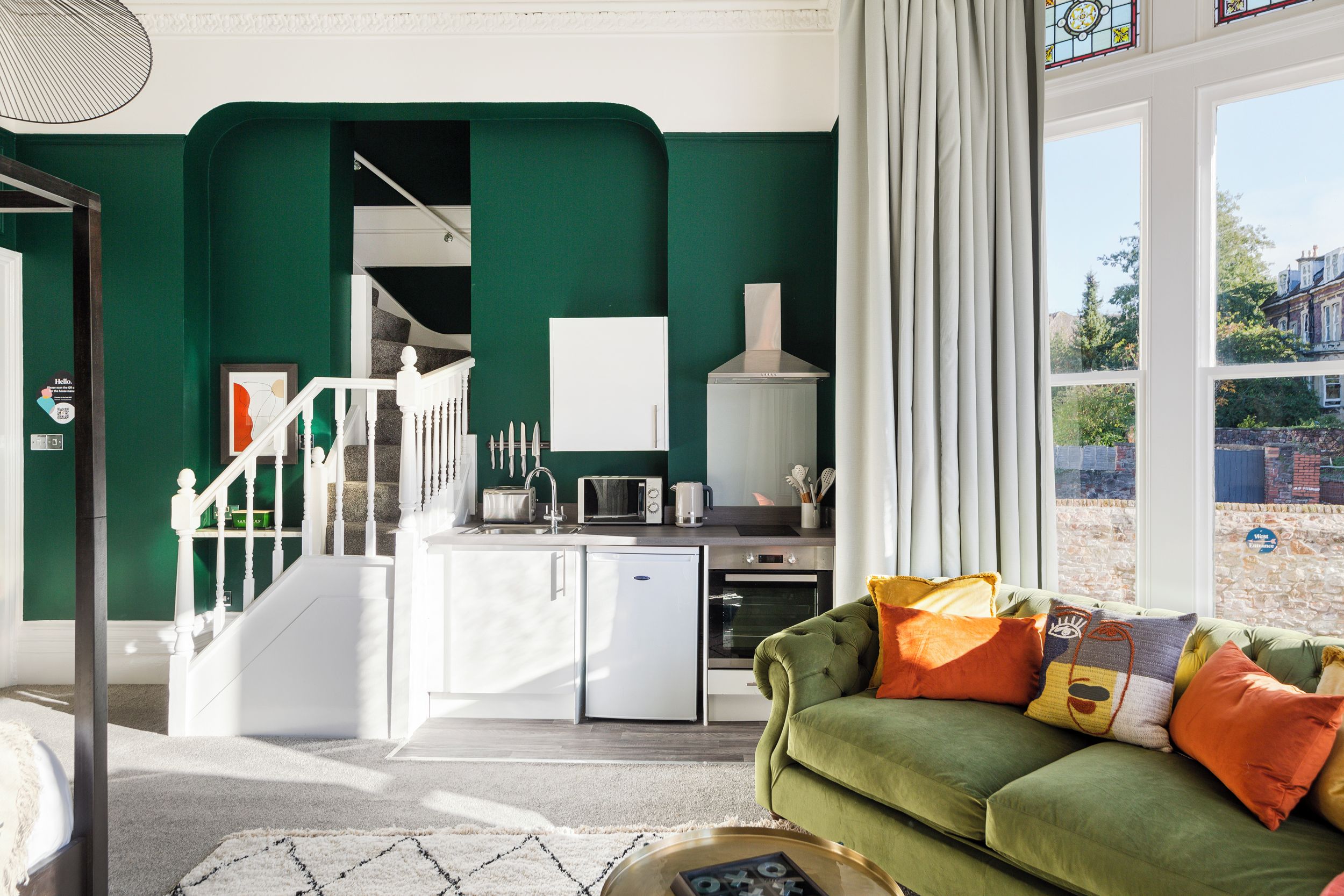 A modern kitchen with white cabinets, a built-in oven, and a refrigerator.