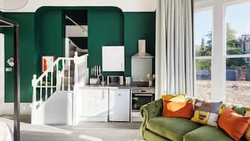 A modern kitchen with white cabinets, a built-in oven, and a refrigerator.