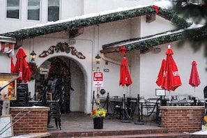 A building with a red lion sign, outdoor seating with red umbrellas, and a 'No Pets Allowed' sign. - Vail Village Walk to Ski, 12ppl, Sebastian Access (Vail)