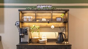 A rustic coffee station with a clock, shelves with mugs, and a coffee maker. - Mimosa Bungalow - Mimosa Bungalow (Crane)