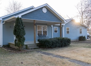 A residential house with a covered porch, a small front yard, and a visible driveway. - Mimosa Bungalow - Mimosa Bungalow (Crane)