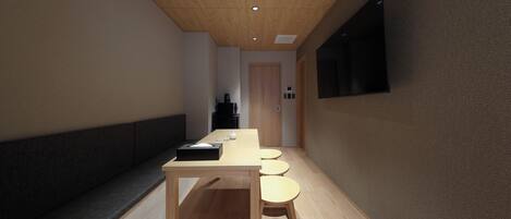 A modern interior with a wooden table and stools, a bench, and a dark-colored sofa.