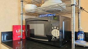 A kitchen area with a microwave, a coffee maker, and a bottle of Dawn Platinum cleaner. - Aloha Surf 706 — Central Waikiki Queen Studio-Suite w/Sofa-Bed&Kitchen ⁂Sleeps 3 (Honolulu)