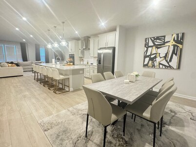 Stylish 4BR/2.5BA home for up to 10 guests with kitchen, patio, and workspace.