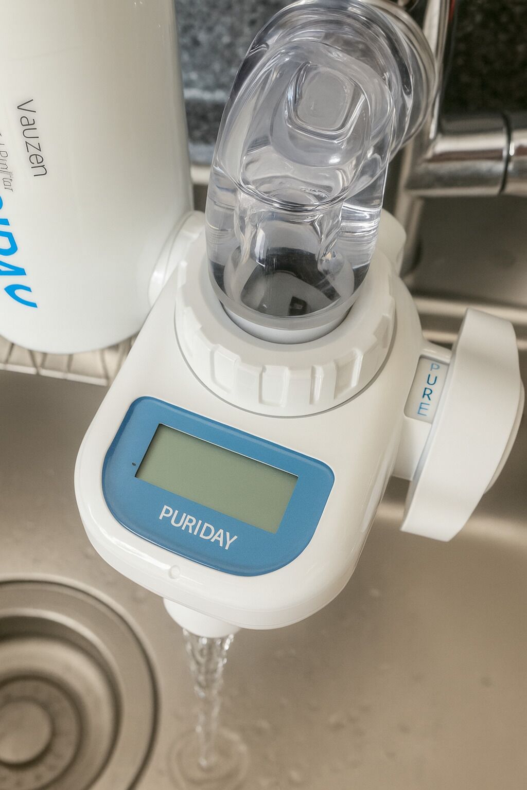 A water purifier with a digital display labeled "PURIDAY" dispensing water.