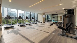 A modern gym with treadmills, elliptical machines, and weightlifting equipment. - Modena by Fraser Nanjing (Nanjing)