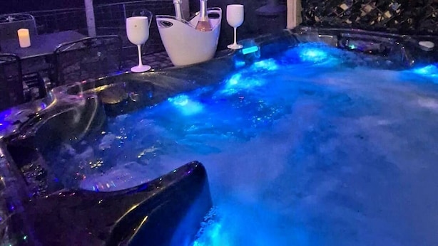 A hot tub area with a wooden ceiling and colorful string lights. - Hot Tub Cottage Near Mourne Mountains | Sleeps 6 + Infants, Pet-Friendly (Ballyward)