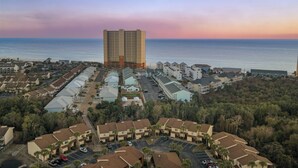 A high-rise hotel with a view of the ocean at sunset. - PCB Condo Near Pier Park + Pool + Pickleball Court | Beachwalk 10B by AvantStay (Panama City Beach)