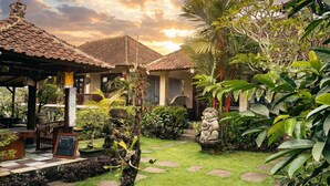 A courtyard with a gazebo, stone steps, and lush greenery. - Putu's Paradise Ubud (Ubud)