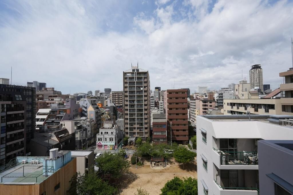 A high-rise building with multiple floors, surrounded by other buildings.